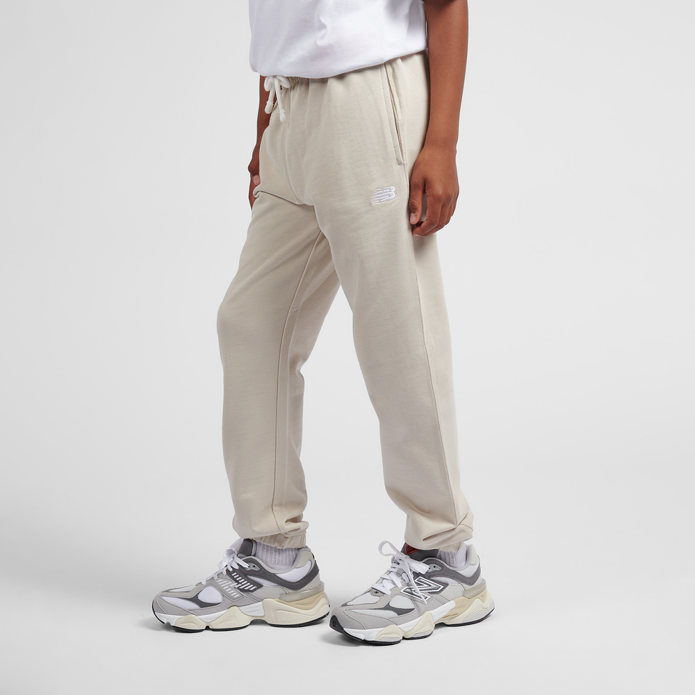 Detské nohavice New Balance LAKB0060TWF – béžové