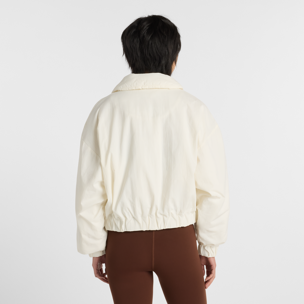 Dámska bunda New Balance WJ61D8YXSST​ – béžové