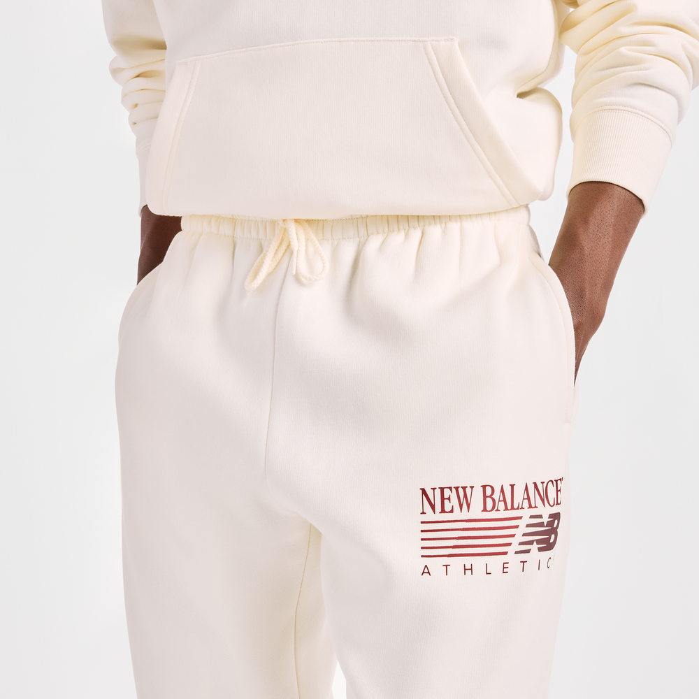 Pánske nohavice New Balance Reimagined Graphic – béžové