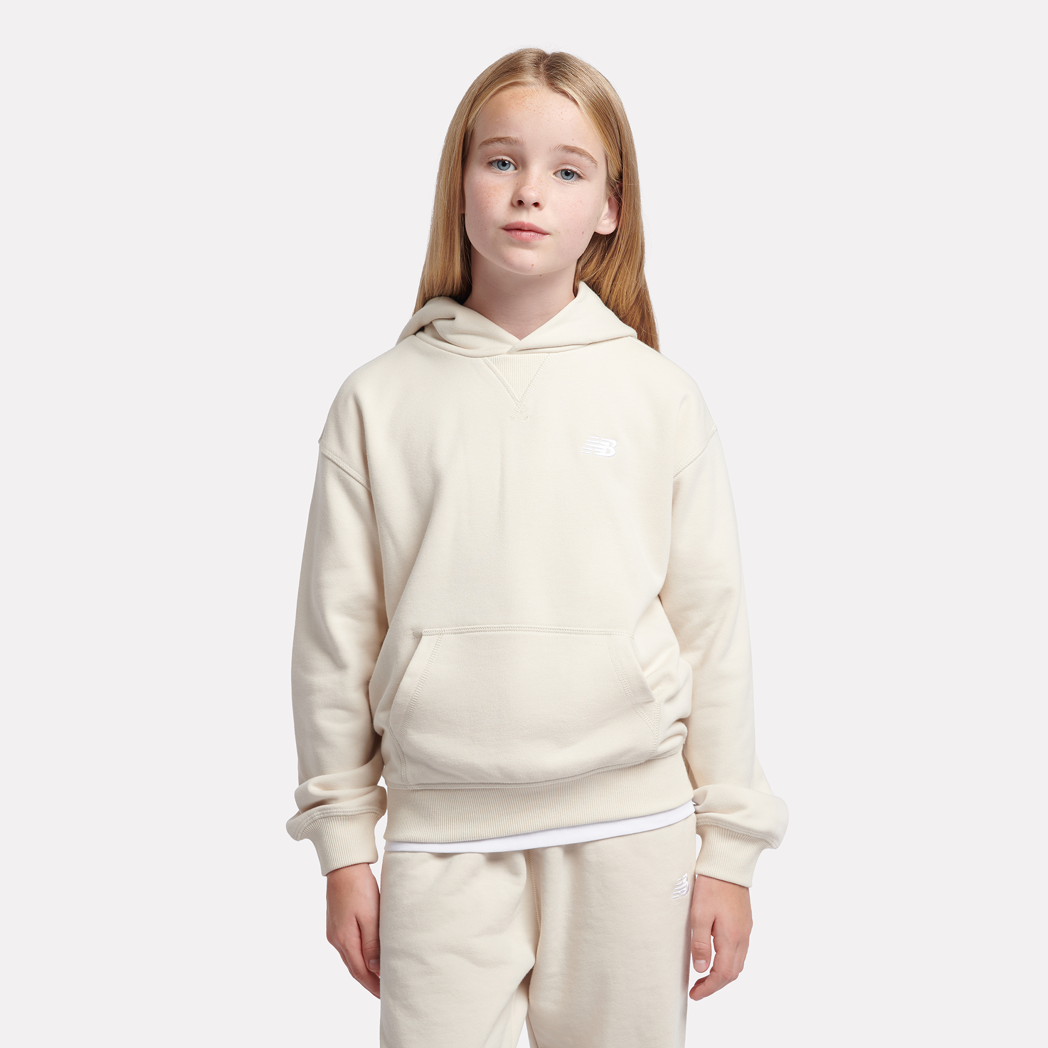Detská mikina New Balance LAKG0056LIN – béžové